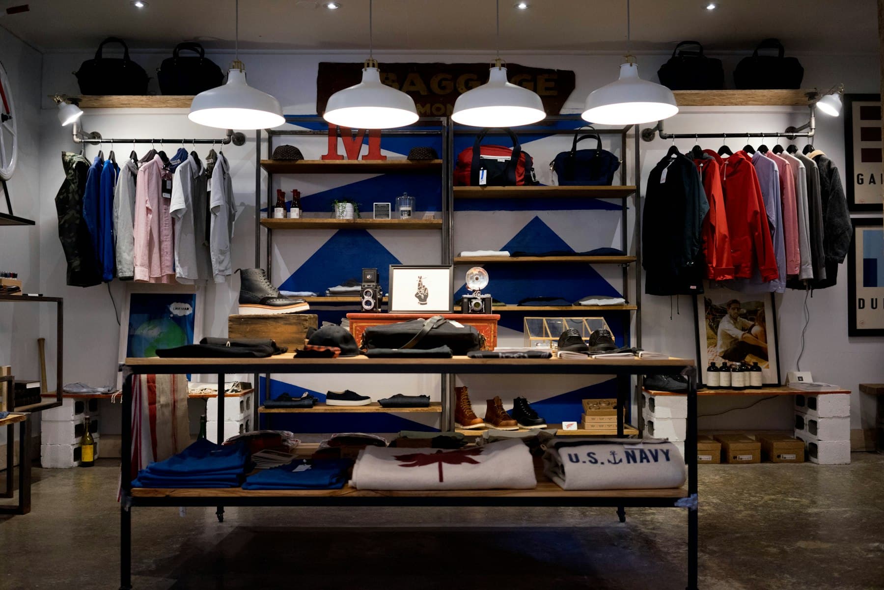 A specialty clothing store with garments displayed on rails and shelves